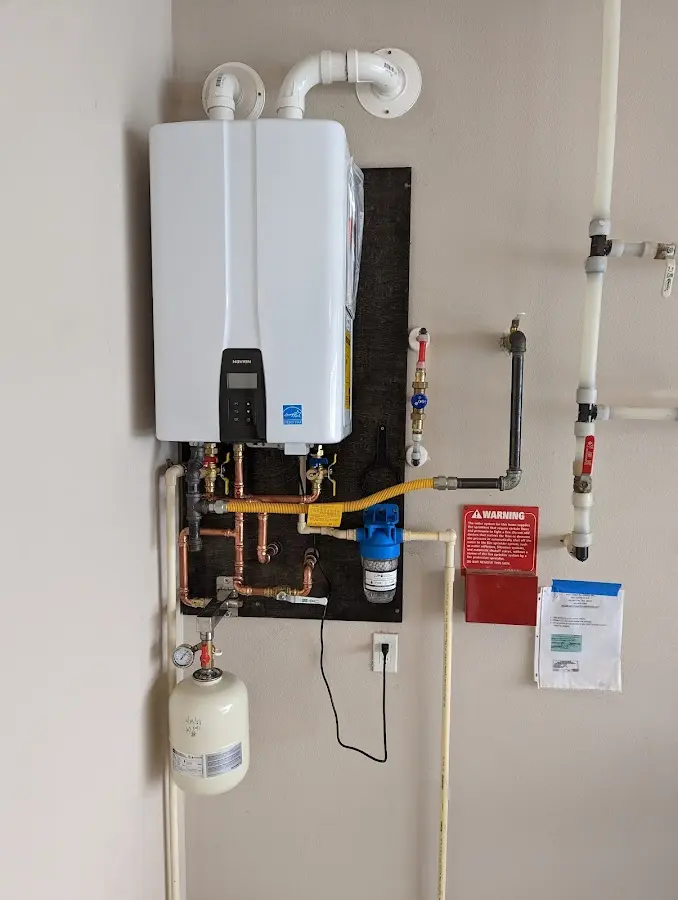 Professional plumber installing copper piping in a Corona home